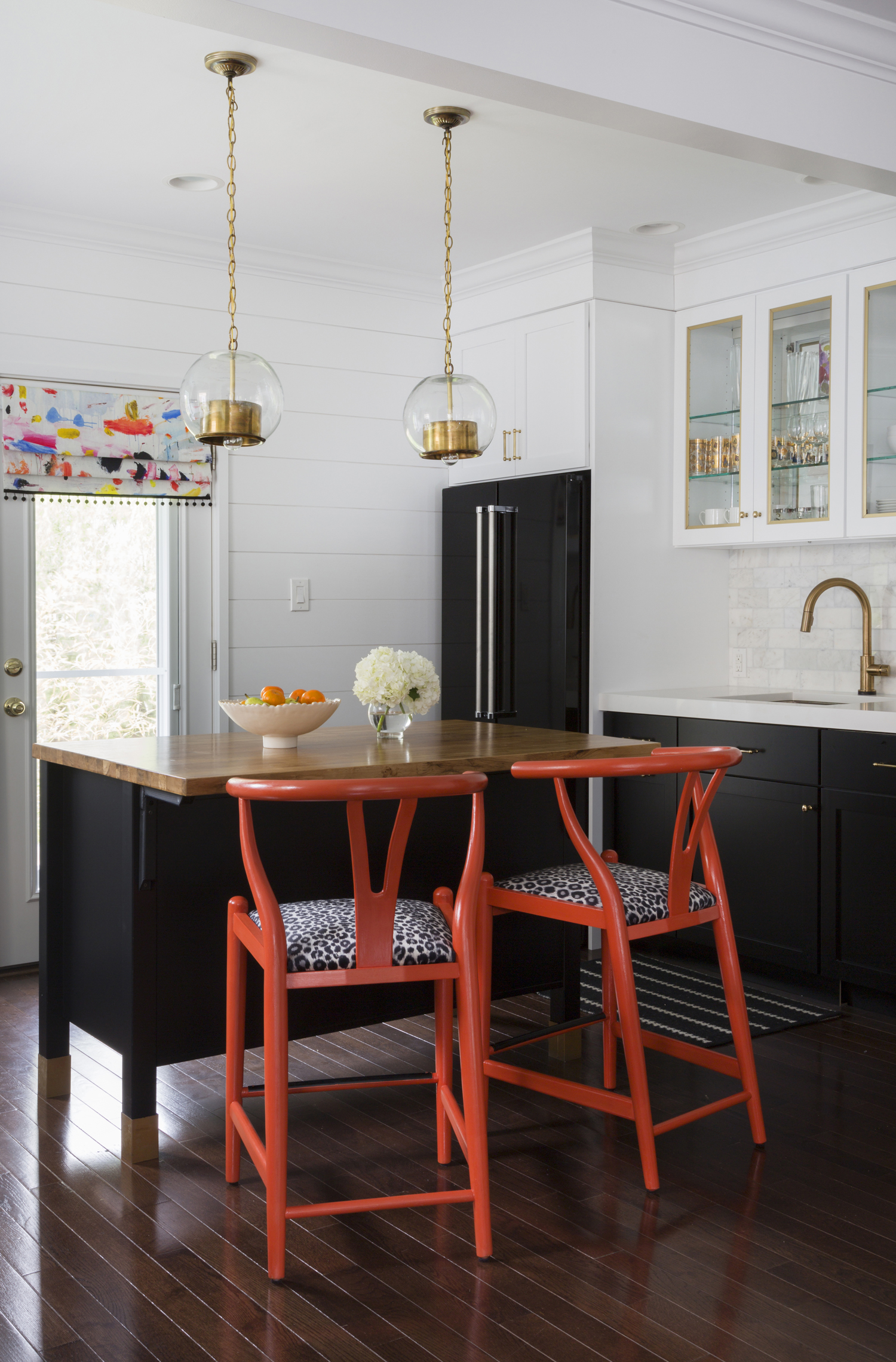 Black-and-White-Kitchen-white-quartz-countertop-marble-backsplash-orange-kitchen-brass-accents-Design-Manifest