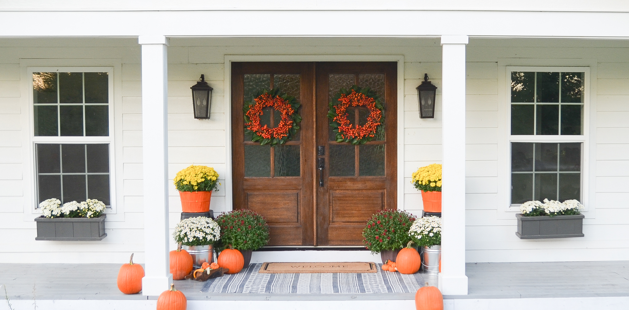 Fall front porch with wreath and pumpkins
